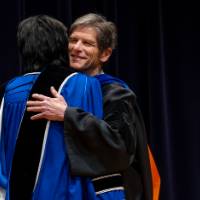 Faculty hugging President